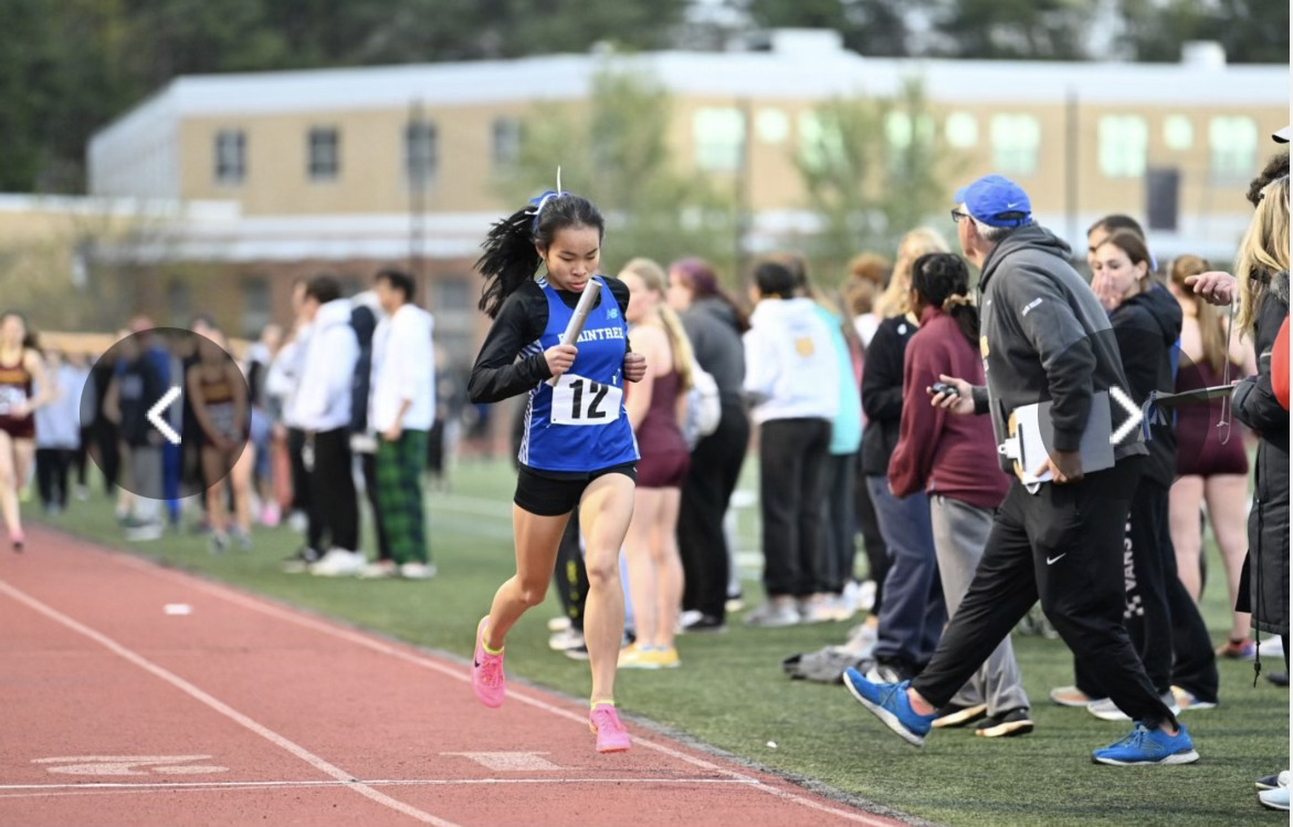 Caitlyn Chang running to the finish line during a spring track meet. Image via Caitlyn Chang