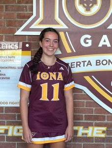 Bella Duffy smiling big in an Iona uniform after receiving her offer. image via Twitter @BraintreeWamps