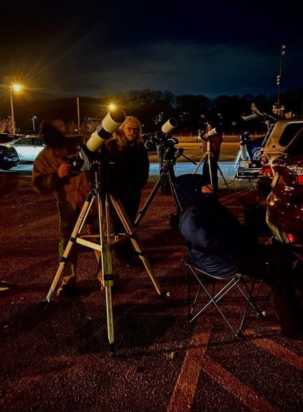 People looking at the telescopes during 2023 Black Out Braintree