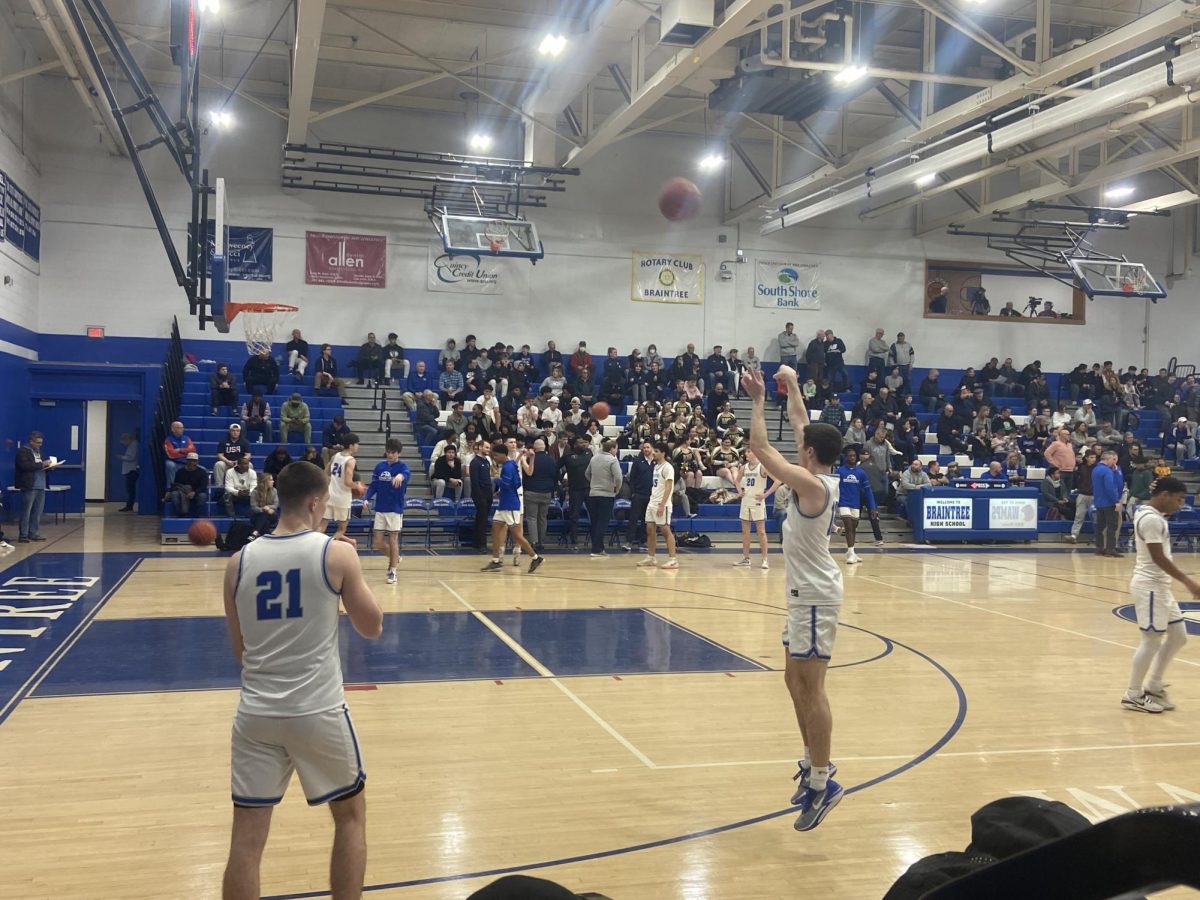 Senior Calum McClorey takes a practice shot during warm-ups before the playoff game against 