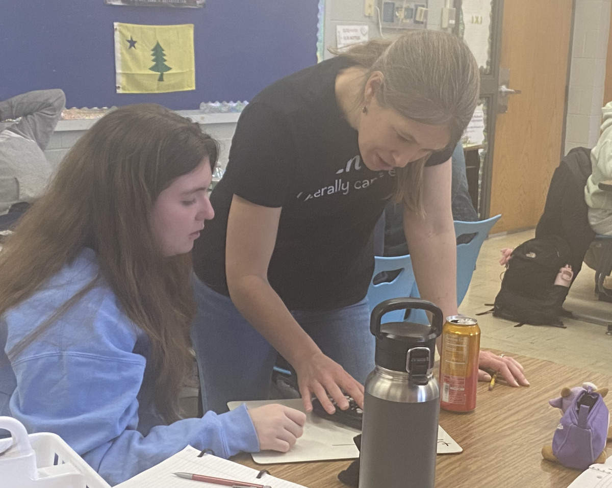 Math teacher Kate Wood assists a student with a challenging problem in AP Calculus BC