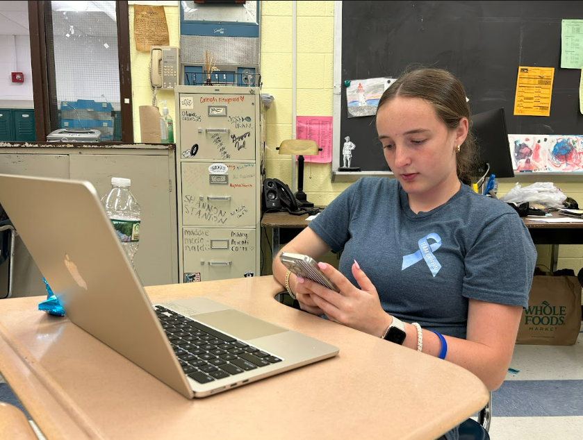 Junior Kathryn Freeman fascinated by social media during class.
