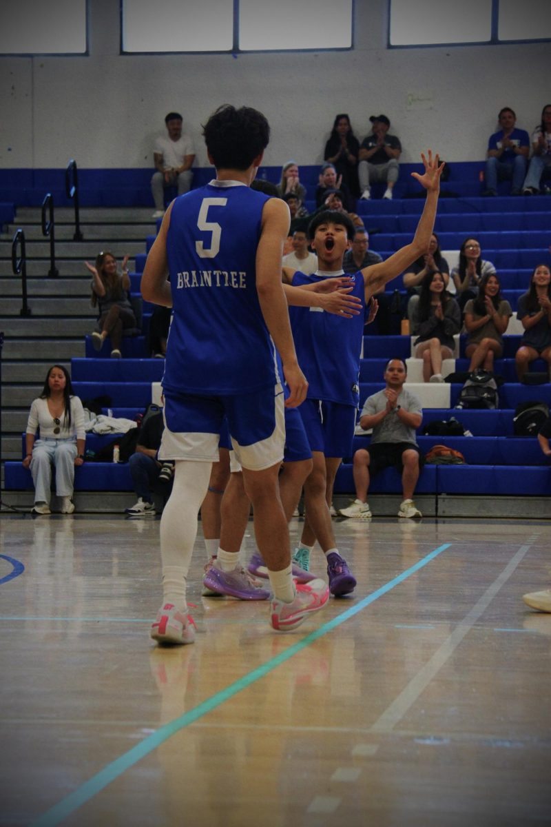 Sophomore Allan Ho, #24, celebrates after winning a point to close the matchup.