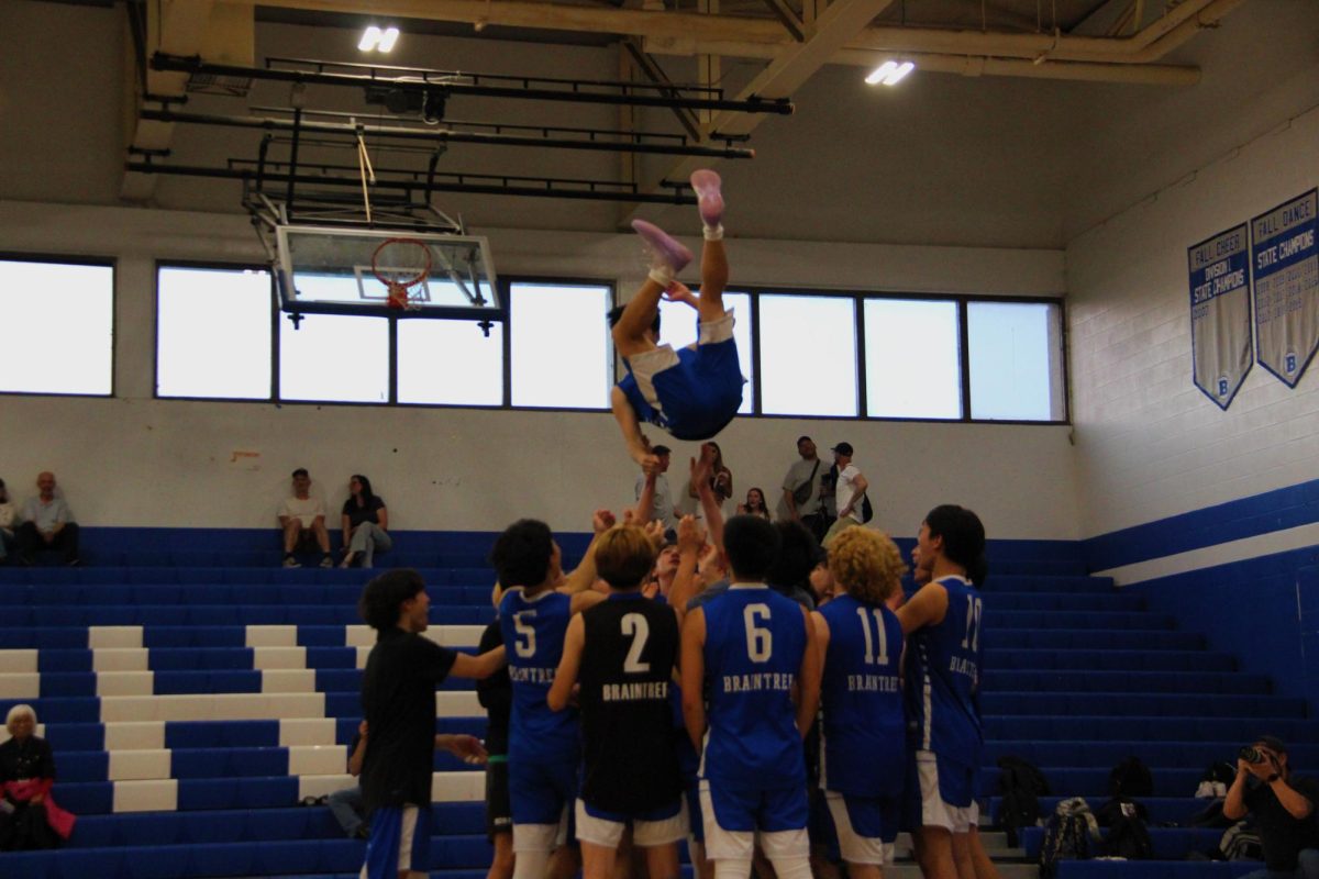 The team tosses up Junior Kyle Hyunh, #18,  in celebration after Braintree defeats Arlington, 3 sets to 1. 
