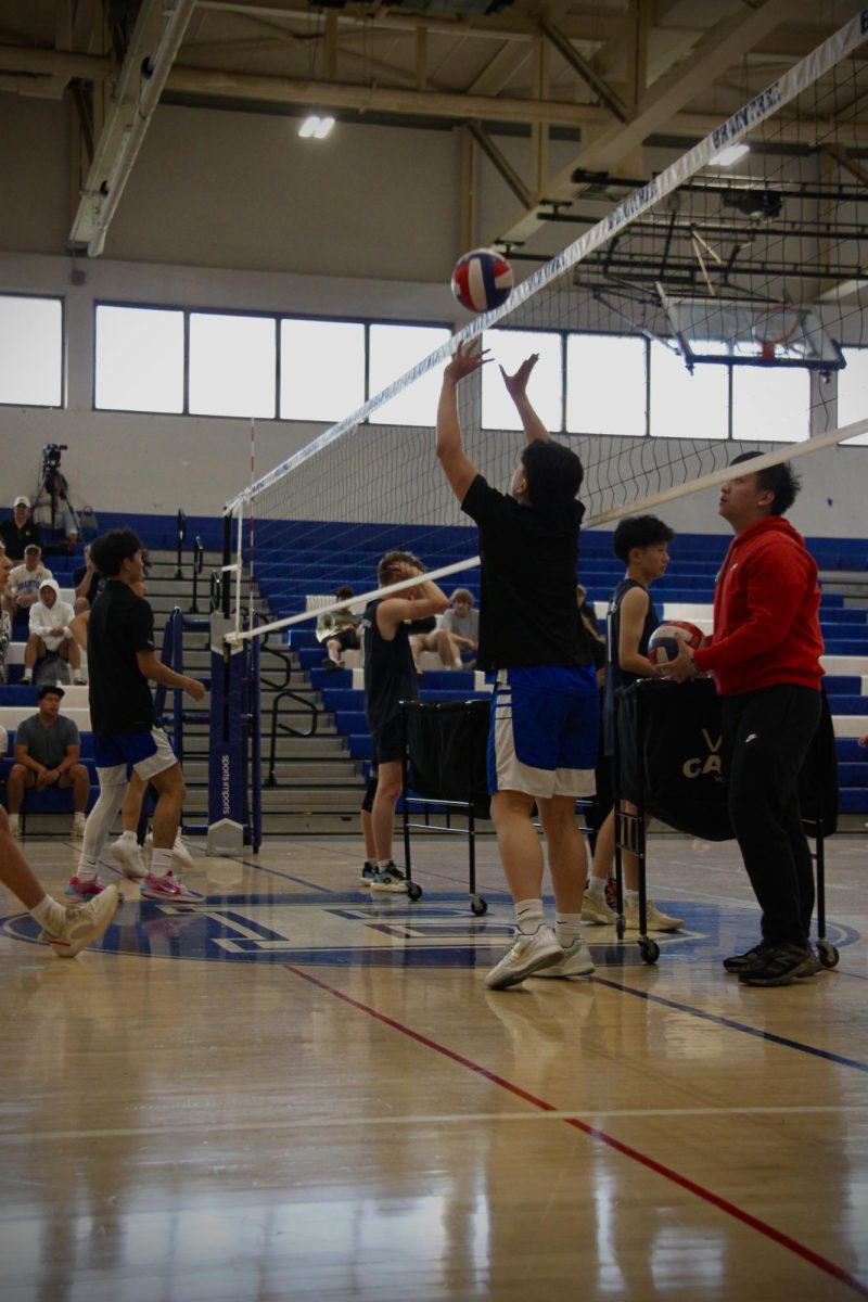 Junior Ryan Wu, #26, sets a ball during warm ups. 
