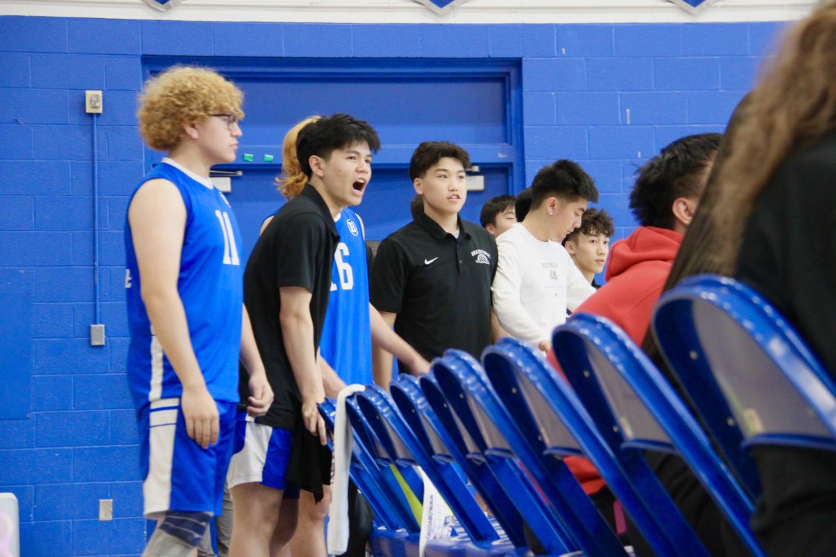 Senior Jack Nguyen cheers on the team. 