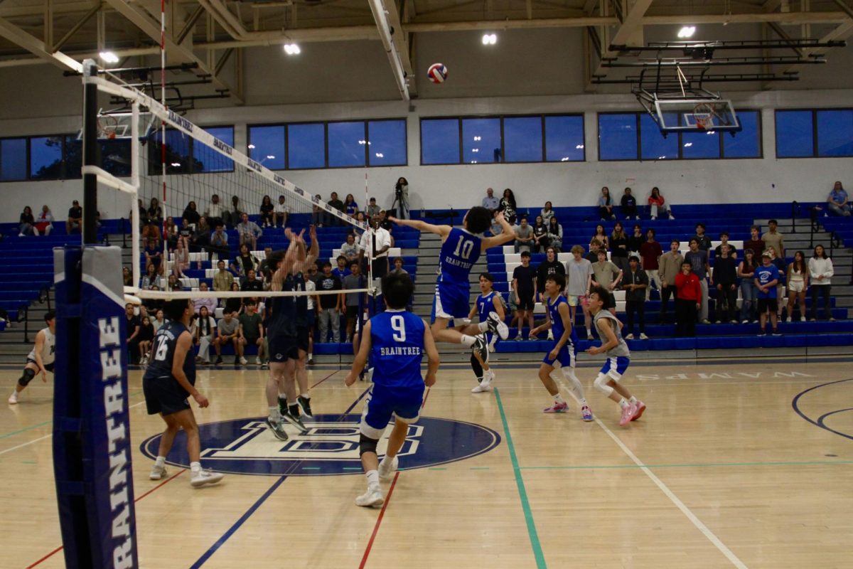 Senior Justin Liu, #10, gets up for a hit.