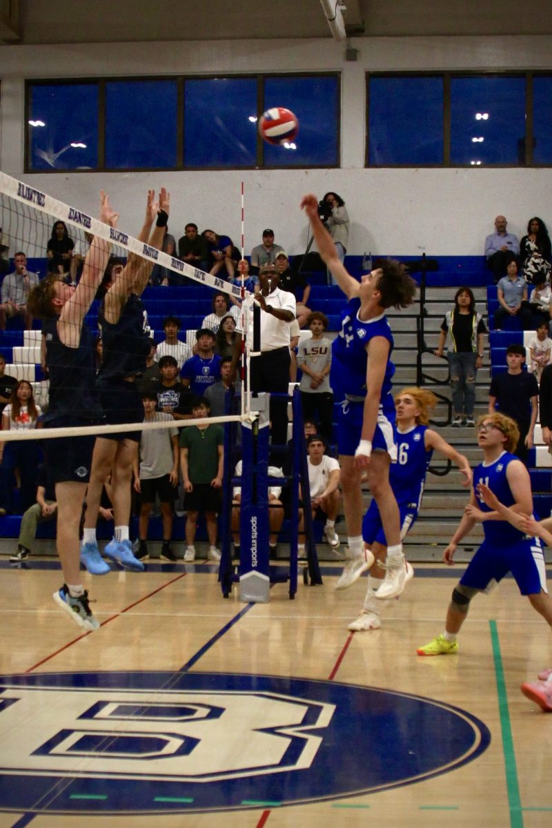 Junior Captain Jack Godderis, #13, gets up to hit a middle ball.