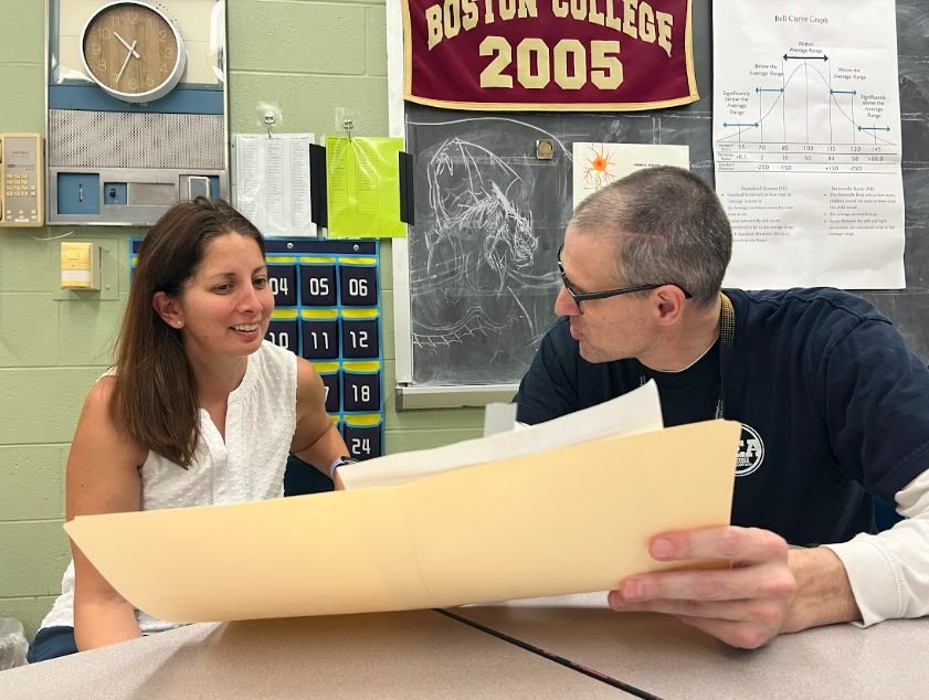 Mrs. Egbert and Mr. Freeman discuss lesson plans together.