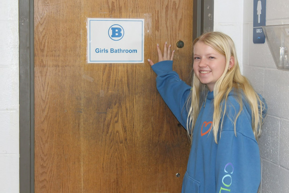 Senior Lexi Fink pushes her way into the now-available bathroom.