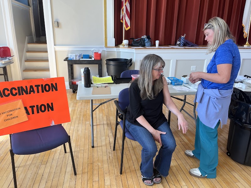 Nurse Jillian Morris administers flu vaccine to Braintree resident Barbara Concannon.