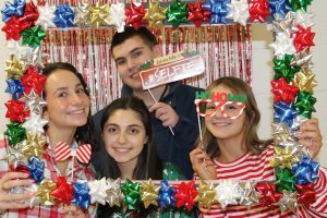 Kayla, Leila, Wills, and Kalina using the photo booth at the Best Buddies holiday party on December 10th in the BHS cafeteria.