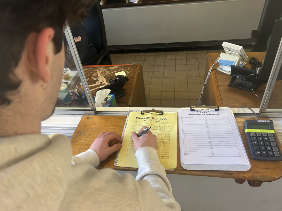 Senior Joe Carroll signs out at the BHS Security Booth in order to leave during a study hall.