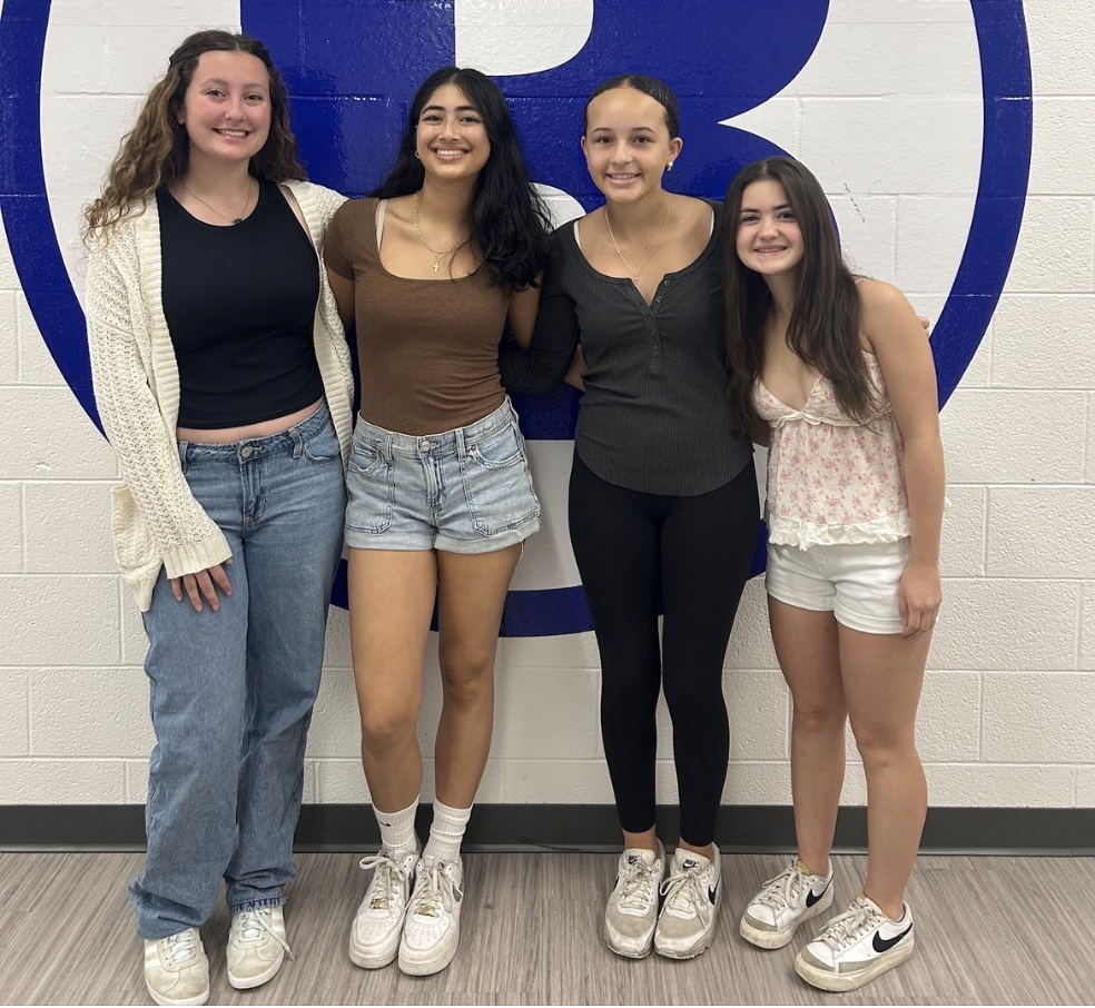 Irelynn Fennessey, Gabriella Tzeng, Sadie Riley, and Izabelle Longobardi pose for a photo outside of the cafeteria. 