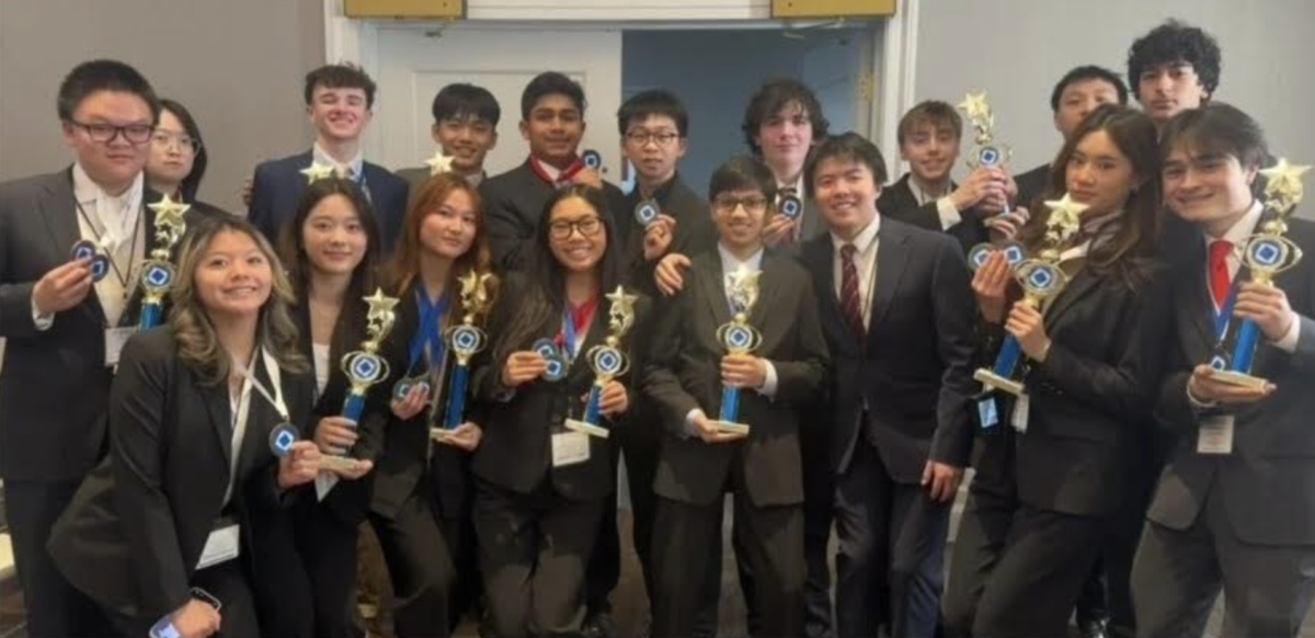 DECA members pose for a photo after winning medals and trophies at the district 1 conference in Quincy. 