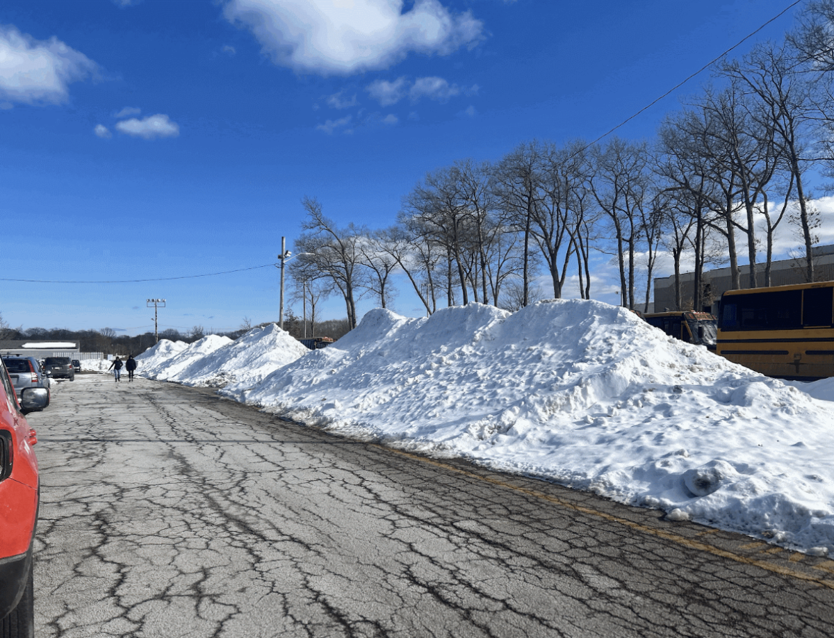 Mounds of plowed snow sit right in front of the student parking lots. 