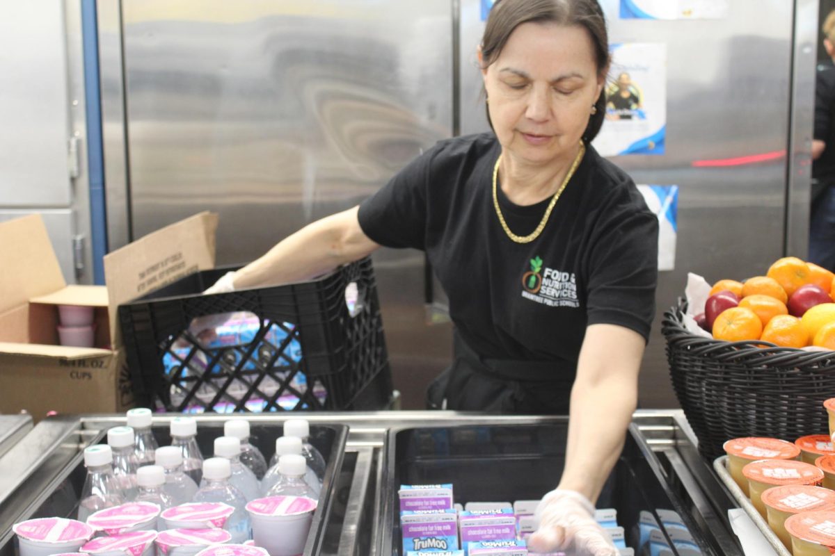 Lucia Doria restocks milk cartons during second lunch in the BHS cafeteria.