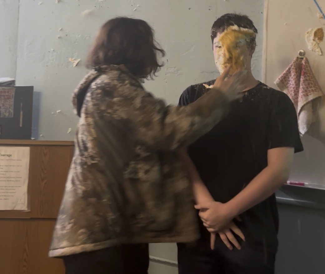 Student Trevor Souza getting pied in the face.