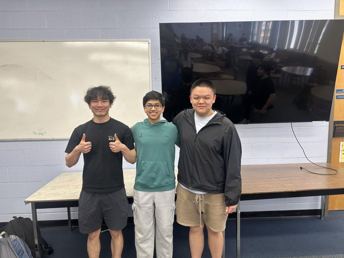 Braintree DECA members Ryan Zhou, Samyak Jain, and Evan Ung pose for a photo during a DECA meeting in the Braintree High Media Center on April 15th. 