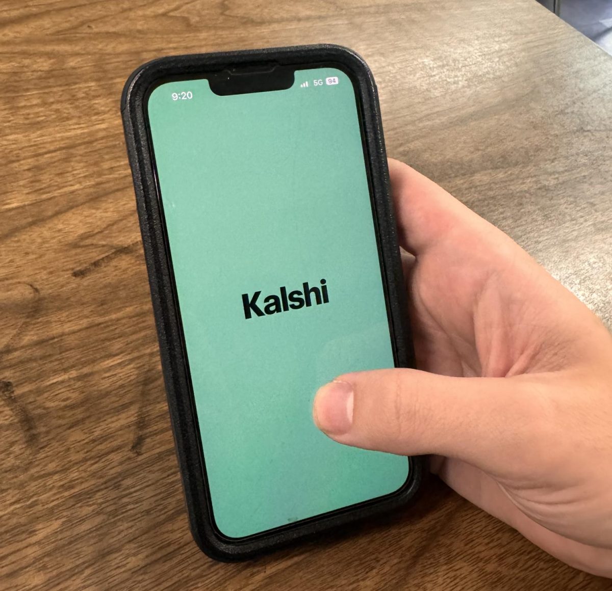 Student uses Kalshi, a popular sports-betting app, on their phone. 